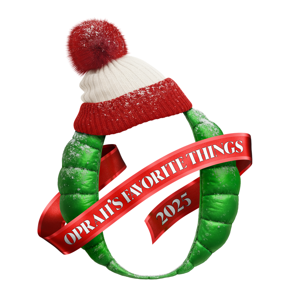 Green wreath with a red ribbon and 'Oprah's Favorite Things 2025' text, wearing a red and white hat.