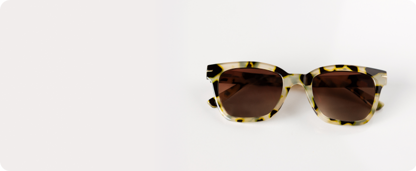 Sunglasses with tortoiseshell frame and brown lenses on a white background