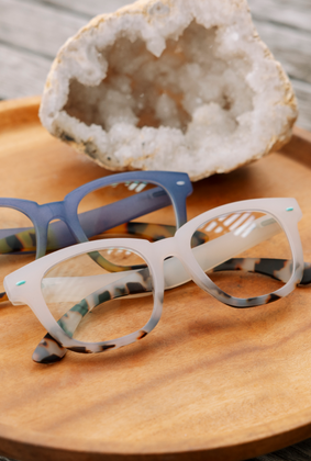 white and blue reading glasses
