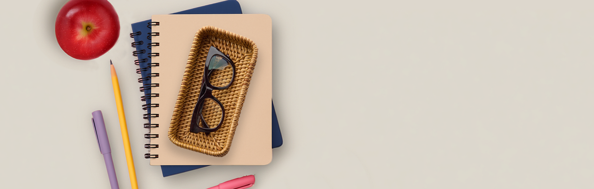 School supplies, notebooks, and Peepers eyewear arranged on a warm surface
