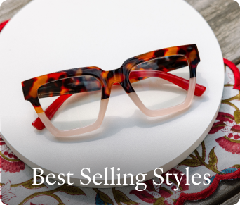 Tortoiseshell and pink glasses on a white plate with floral tablecloth