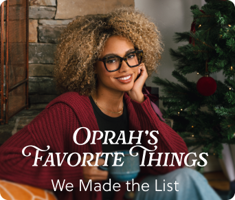 Woman with glasses and a red sweater sitting in front of a Christmas tree with text overlay 'Oprah's Favorite Things'.