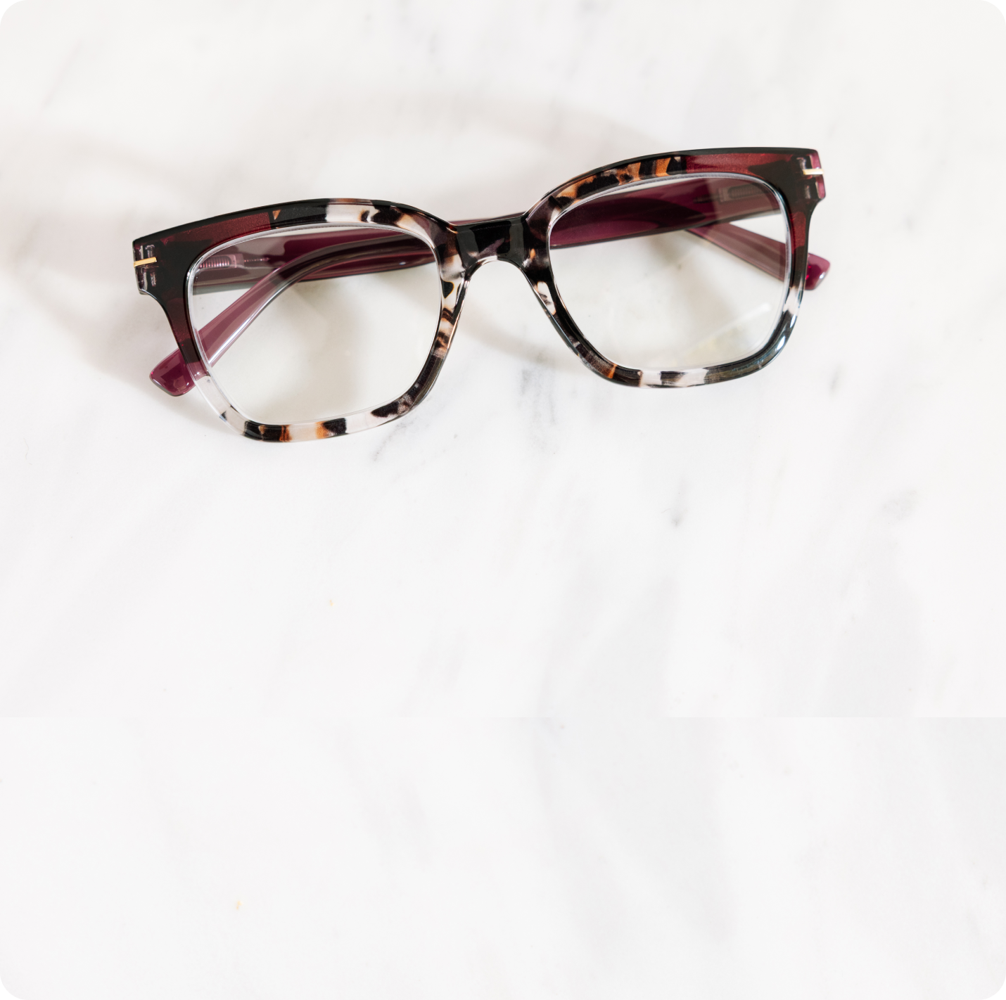 Pair of glasses with a tortoiseshell frame on a white background
