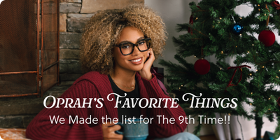 Woman sitting by a Christmas tree with text "Oprah's Favorite Things"