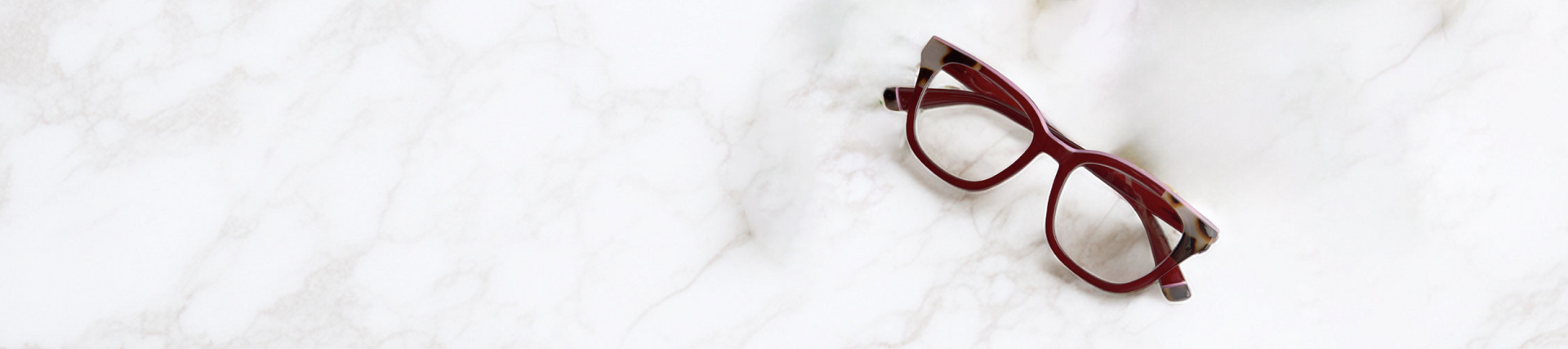 Red eyeglasses on a white background