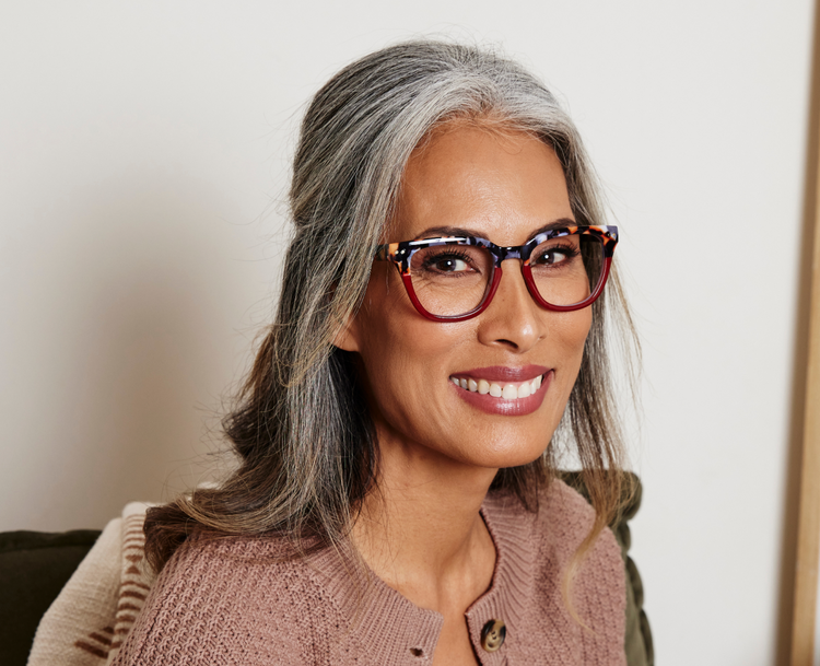 "The Lens" image representation. Female model smiling, wearing frames