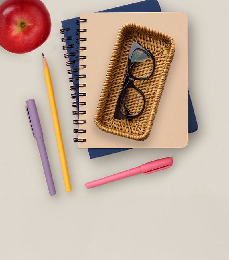 School supplies, notebooks, and Peepers eyewear arranged on a warm surface