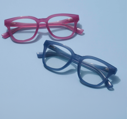 Pink and blue reading glasses on a blue background 