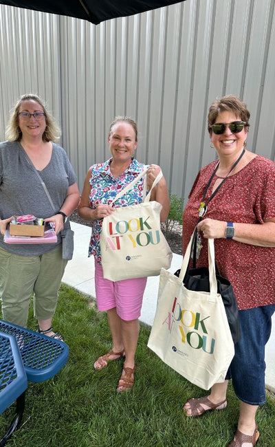 Peepers for Teachers volunteers sorting donated supplies into boxes