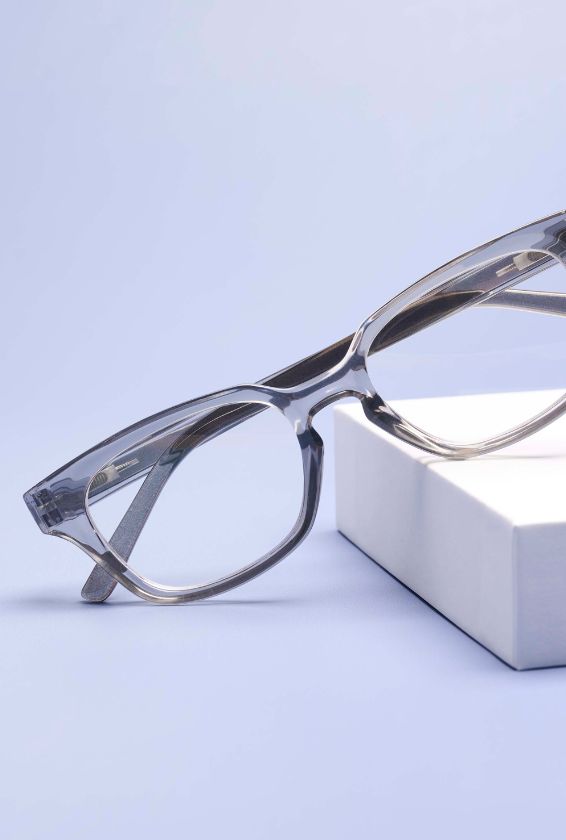 Gray Clive reading glasses with a light purple background 
