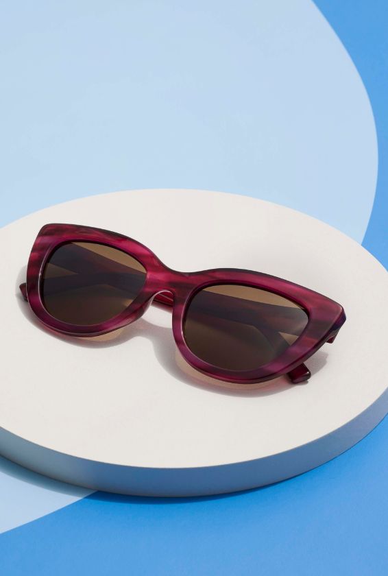 Magenta Capri sunglasses with a blue background 
