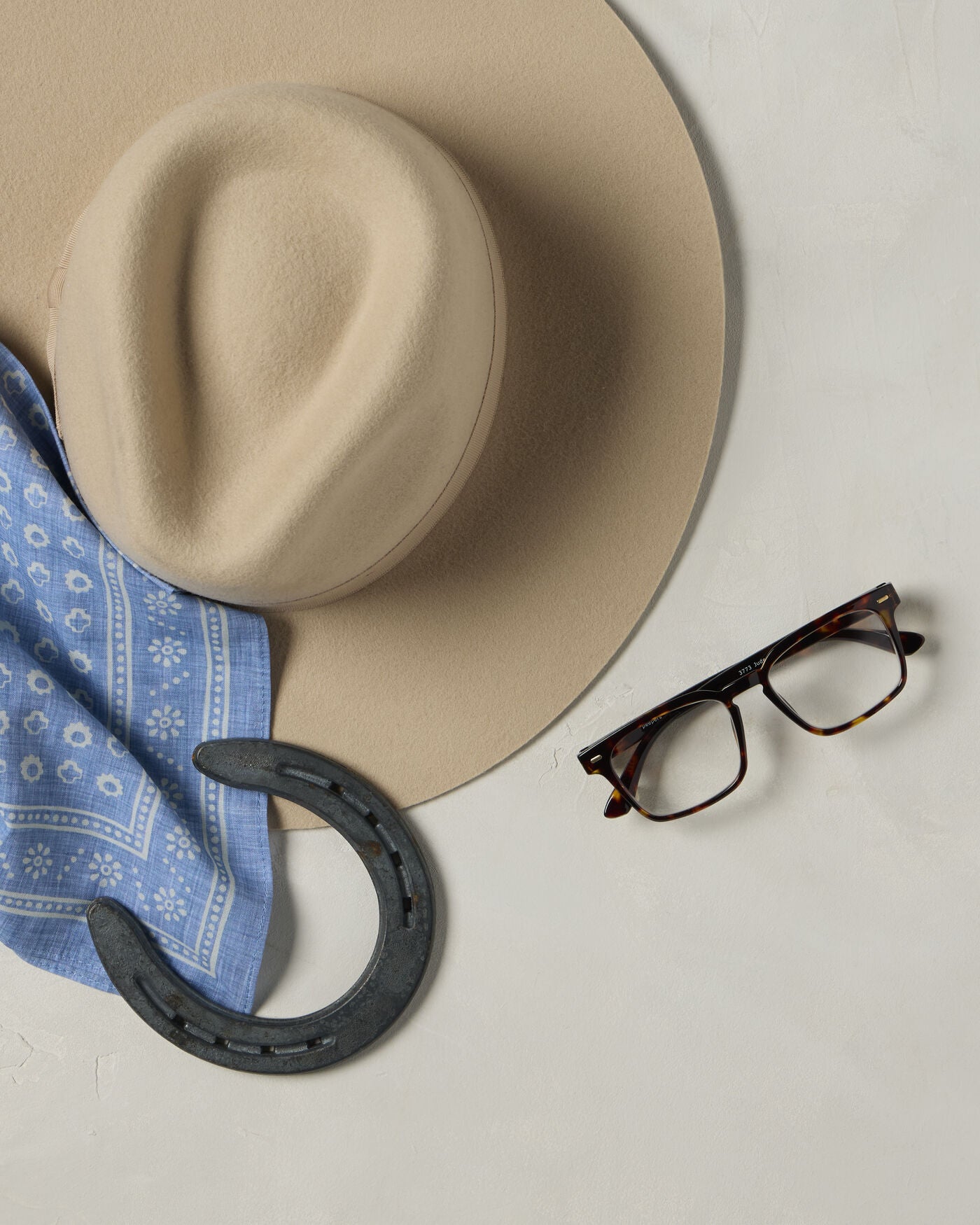 Jude frames with cowboy hat, horseshoe, and bandana